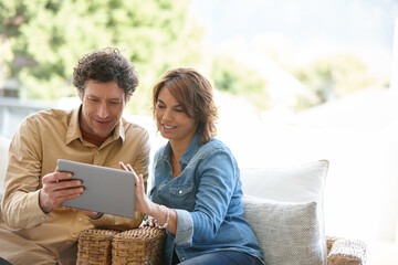 Logging into their joint email account. Shot of a husband and wife using a digital tablet together...