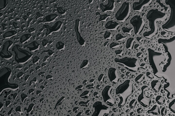 Water drops on black surface background. Raindrops for overlaying on window, concept of autumn weather,