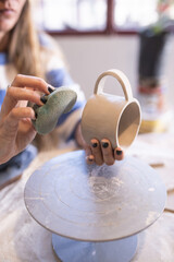 woman making ceramic handicrafts on a table
