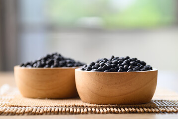 Black soybean seeds in wooden bowl, Food ingredients