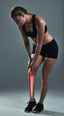 If your legs give up, go with your heart. Studio shot of a sporty young woman suffering from a knee injury.