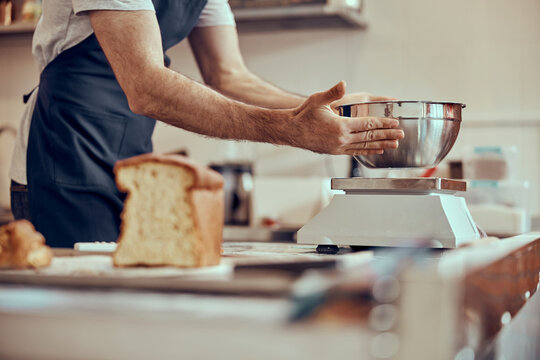 Male worker hands putting bowl on electronic scales