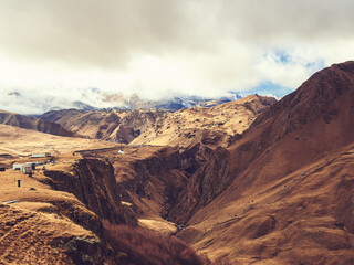 A mighty snowy Elbrus hides behind the clouds in the distance. Jily su mountain valley in autumn