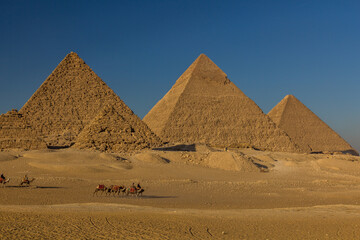 Fototapeta na wymiar CAIRO, EGYPT - JANUARY 28, 2019: Camel riders in front of the Great pyramids of Giza, Egypt
