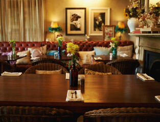 Shall we be seated. Shot of a cozy home interior with a set dining table in the foreground.