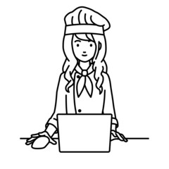デスクで座ってPCを使っている調理師の女性
