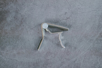 Guitar capo isolated on gray background