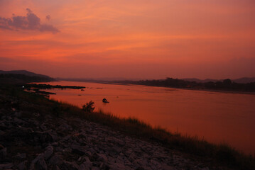 Scenic view dramatic beautiful sunset sky. Natural Sunset Sunrise on meadow silhouette shadow dark land. Vibrant dramatic sky on sunset, dawn, sunrise in Countryside. Landscape Colorful Sky At Sunset