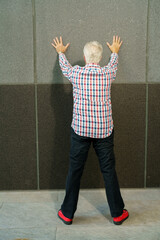 Man with hands on the wall
