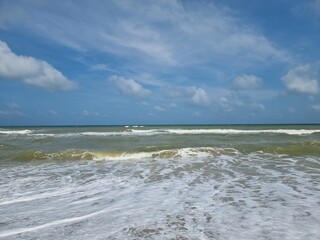 dark blue ocean wave and blue sky on clean sandy beach