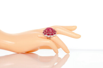 Ruby Sapphire with diamonds ring on plastic mannequin female hand. Collection of natural gemstones accessories. Studio shot