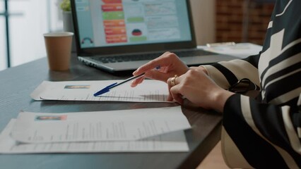 Office worker searching expertise information on resume for job application and vacancy hiring. Recruiter looking at cv documents, work experience forms for applicants career. Close up.