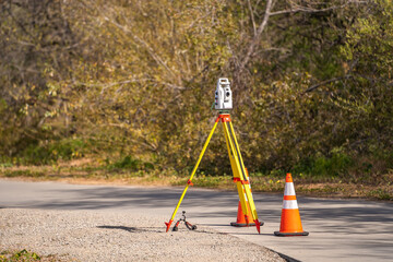 Geodetic measuring equipment stands on the park. Topographic survey of the area.