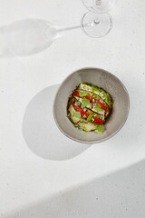 Vegetable ratatouille with zucchini, eggplant and paprika on summer style with hard shadow. Baked...