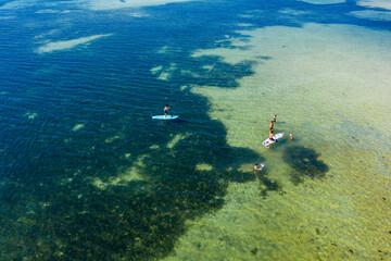 Fototapeta na wymiar tourists are sailing Stand-up paddle (SUP) at sea in Phu Quoc island, Vietnam