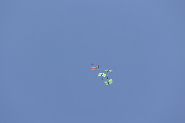 Naklejka na ściany i meble People Skydiving with a clear blue sky