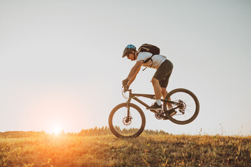 Naklejka premium Cyclist Riding the Bike on the Trail in the Forest. Man cycling on enduro trail track. Sport fitness motivation and inspiration. Extreme Sport Concept. Selective focus
