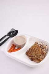 Grilled chicken with rice with delivery take home package isolated in white background