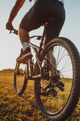 Fototapeta na wymiar Cyclist Riding the Bike on the Trail in the Forest. Man cycling on enduro trail track. Sport fitness motivation and inspiration. Extreme Sport Concept. Selective focus