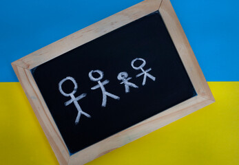 conceptual image with Ukrainian flag colors and children’s drawing illustrating, war, refugees...