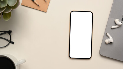 Top view office stuff with smartphone white screen mockup
