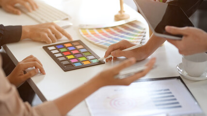 Designers working together in the office, discussing the interior design.