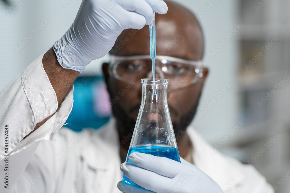 Poster gloved hands of contemporary chemist with pipette dropping liquid substance into tube during scienti