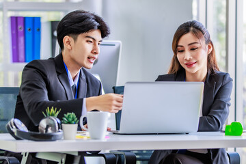 Asian young happy professional male businessman mentor and female businesswoman colleague in formal...