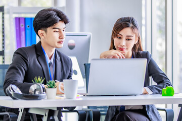 Asian young happy professional male businessman mentor and female businesswoman colleague in formal...