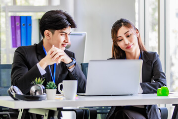 Asian young happy professional male businessman mentor and female businesswoman colleague in formal...