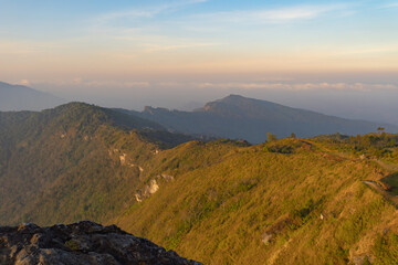 Aerial top view of forest trees and green mountain hills with fog, mist and clouds. Nature landscape background, Thailand.