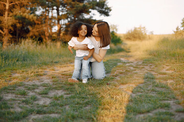 Caucasian mother embracing her mixed race daughter