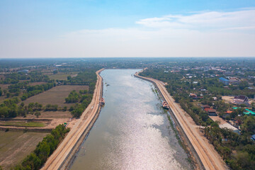 Aerial top view of Bueng Sa Bua Pond. River lake with forest trees, green mountain hills,  or lake. Nature landscape background, Thailand.