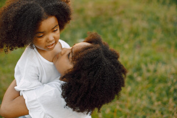 Two african american sister embracing in a park