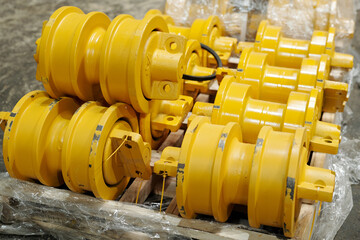Group of yellow metal spare parts for modern industrial or construction machines made in...