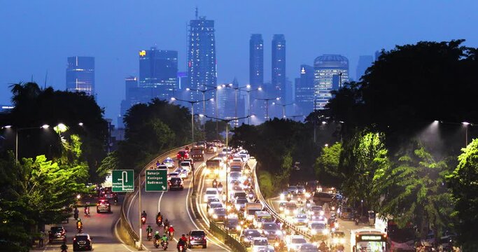 Beautiful busy traffic road with glowing highrise
