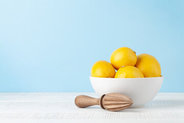 Fresh lemons and juicer