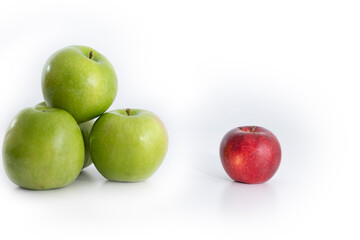 apples of different color and size on white background. apartheid concept.