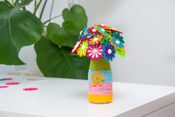 Vase with colorful felt flowers. DIY craft for Mother's Day.