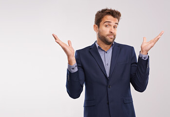 Whatever.... Studio shot of a businessman shrugging against a gray background.