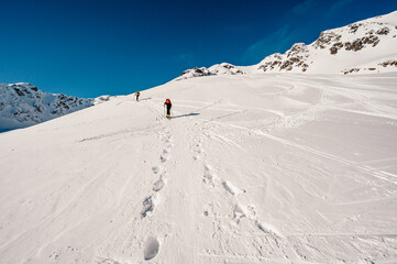 Ziarska dolina, slovakia, 10.2.2022. Mountaineer backcountry ski walking ski alpinist in the mountains. Ski touring in alpine landscape with snowy trees. Adventure winter sport. © Zedspider