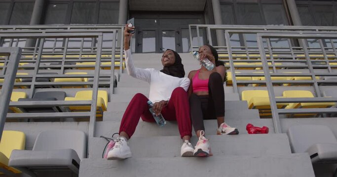 Fit black girls having taking a selfe with smartphone after running