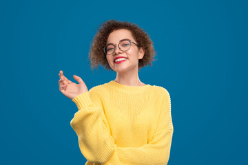 Charming woman pointing away in studio