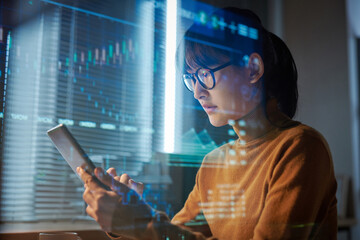 Young woman in eyeglasses projecting the program on digital tablet during her work at office