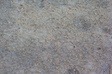 Texture of the dried earth. Gray background with cracks and hollows. Drought and lack of moisture...