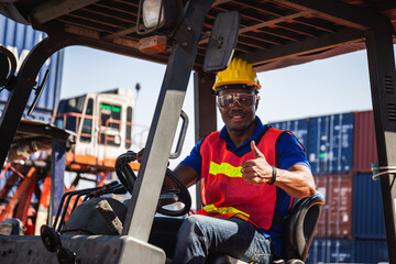 Forklift driver showing thumbs up, Worker man in hardhat and safety vest sitting in container stackers
