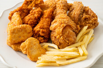 fried chicken with french fries and nuggets on plate