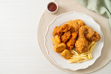 fried chicken with french fries and nuggets on plate