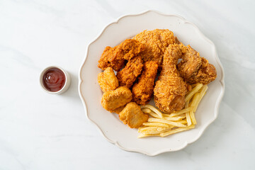 fried chicken with french fries and nuggets on plate