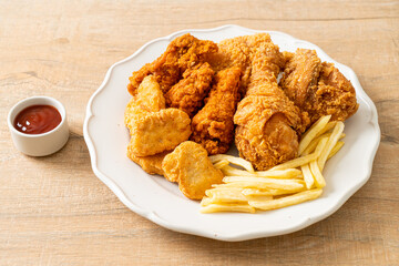 fried chicken with french fries and nuggets on plate